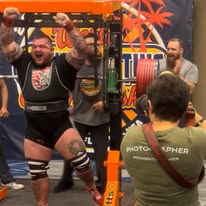 Coach Joshua Land celebrating after a successful powerlifting attempt